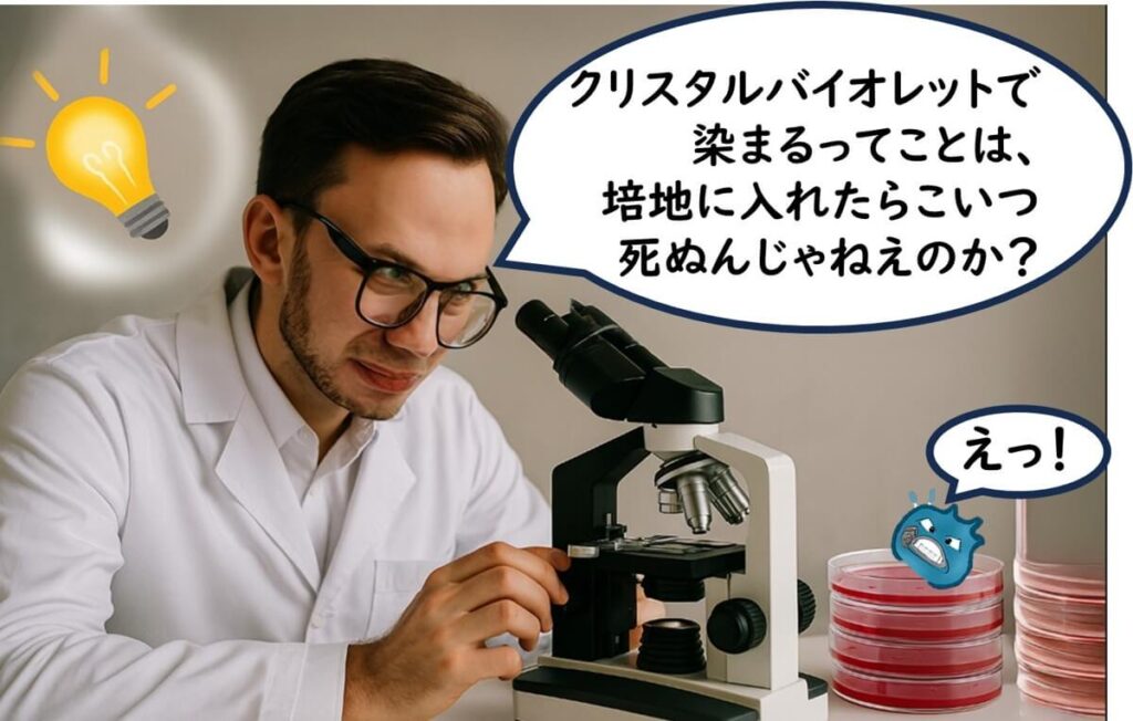 顕微鏡をのぞきながら「染まる＝死ぬ？」とひらめいた男性研究者のイラスト。

